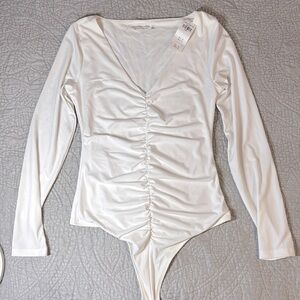 Abercrombie & Fitch white shirted long sleeve body suit. NWT.